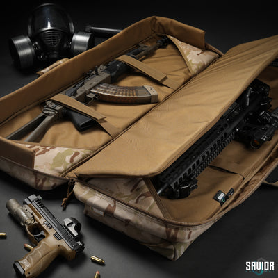 Double Rifle Slots - 1000D Multicam fabric interior. Extra padding for all-around protection. Straps to lockdown your firearms during transportation. Firearms shown not included.#color_multicam-arid